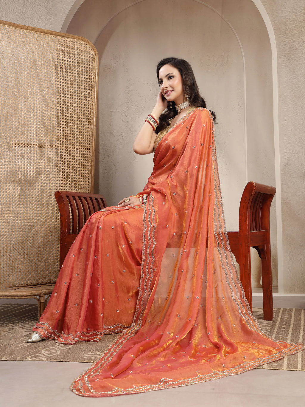 Model Sitting in Rust Orange Space Silk Designer Saree
