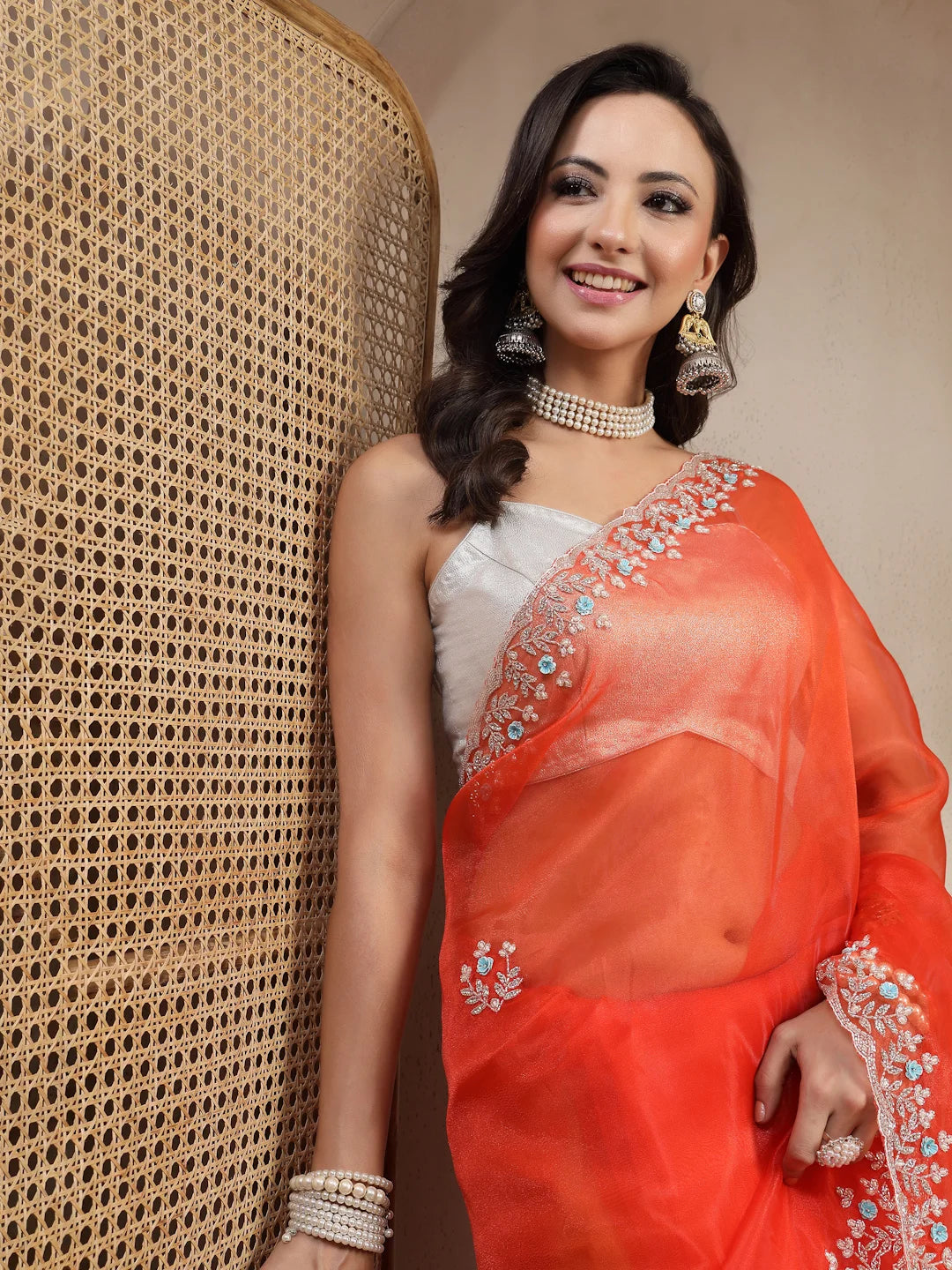Model Wearing Orange Tissue Saree with White Floral Border
