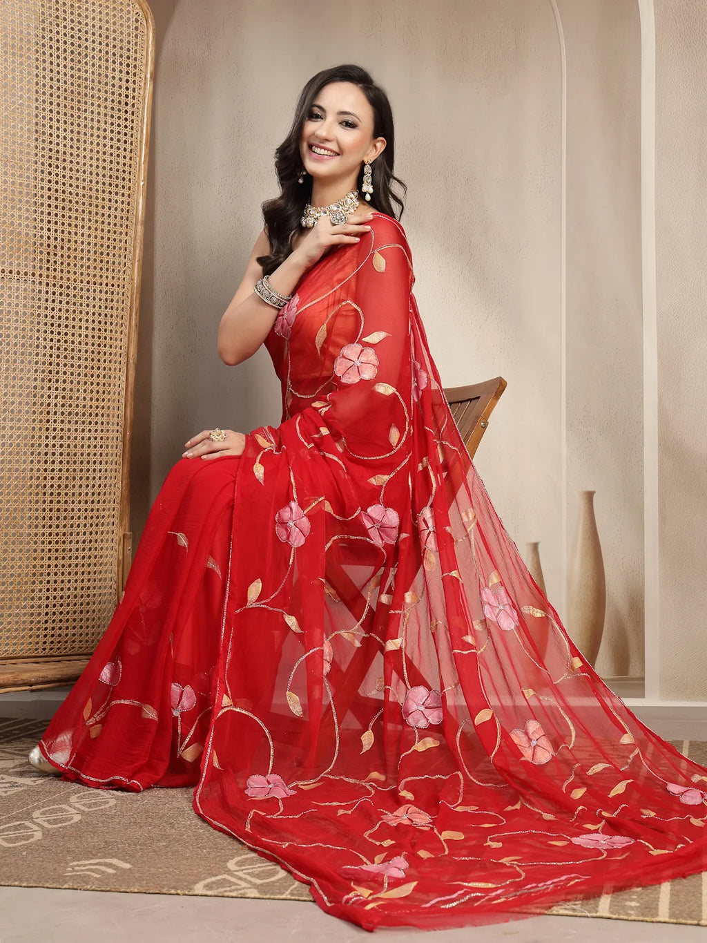 Model Sitting View in Red Handpainted Semi Chiffon Saree
