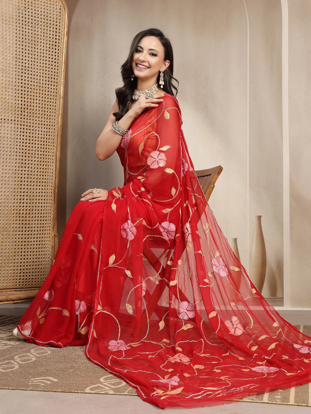 Model Sitting View in Red Handpainted Semi Chiffon Saree
