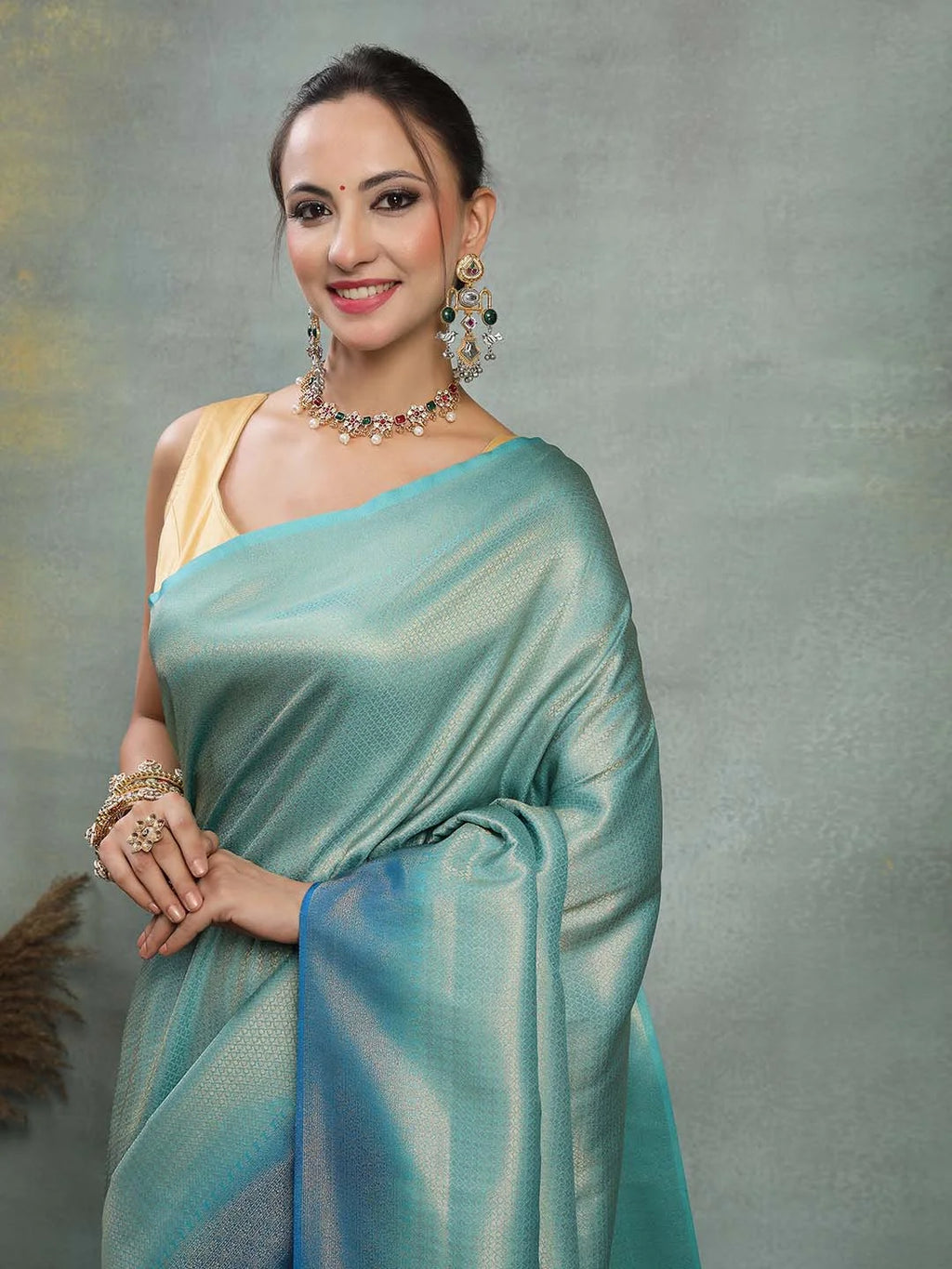Model Portrait Wearing Firozi and Royal Blue Kanjivaram Silk Saree
