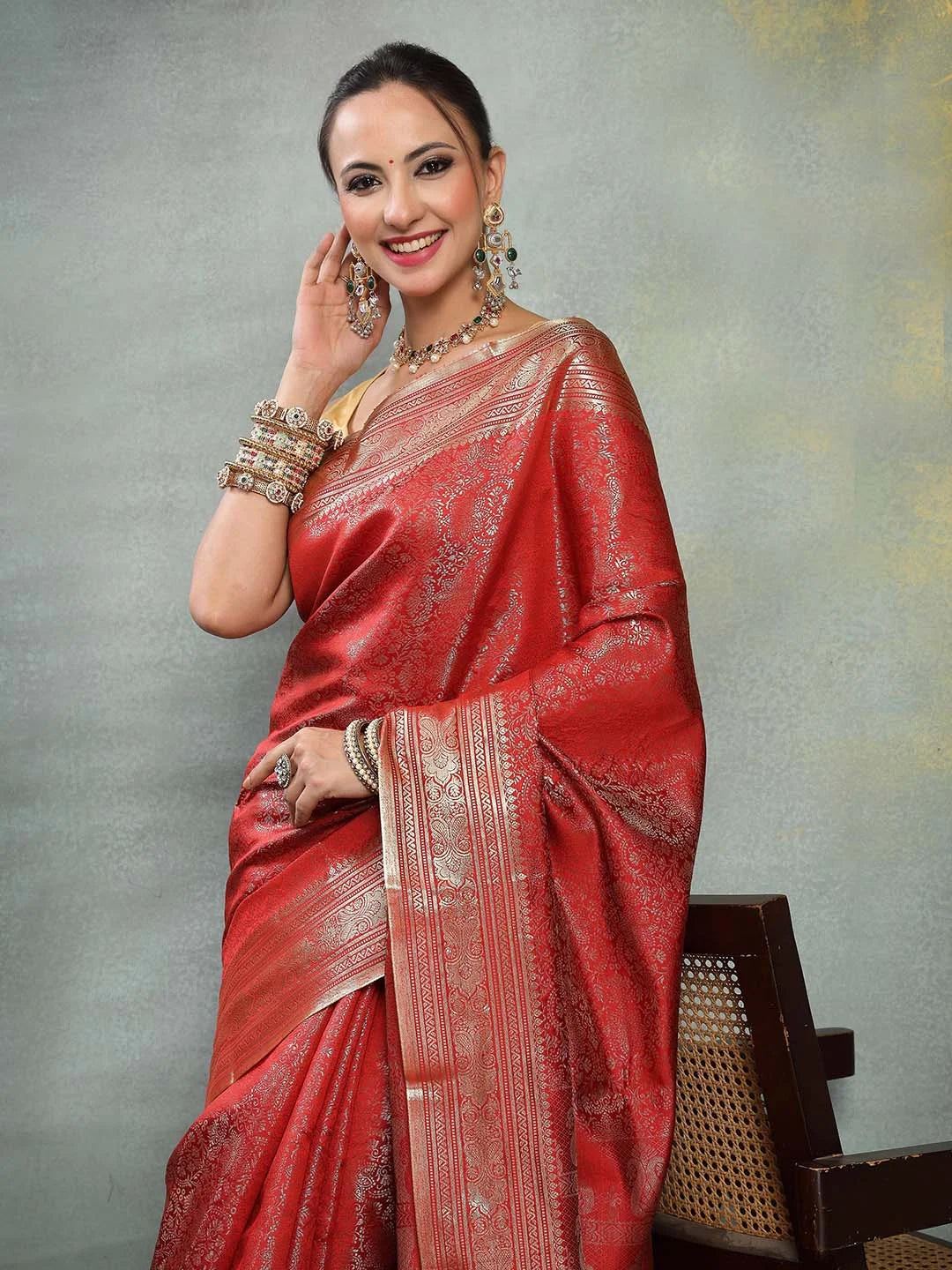 Model Wearing Red Banarasi Silk Saree with Traditional Gold Jewelry
