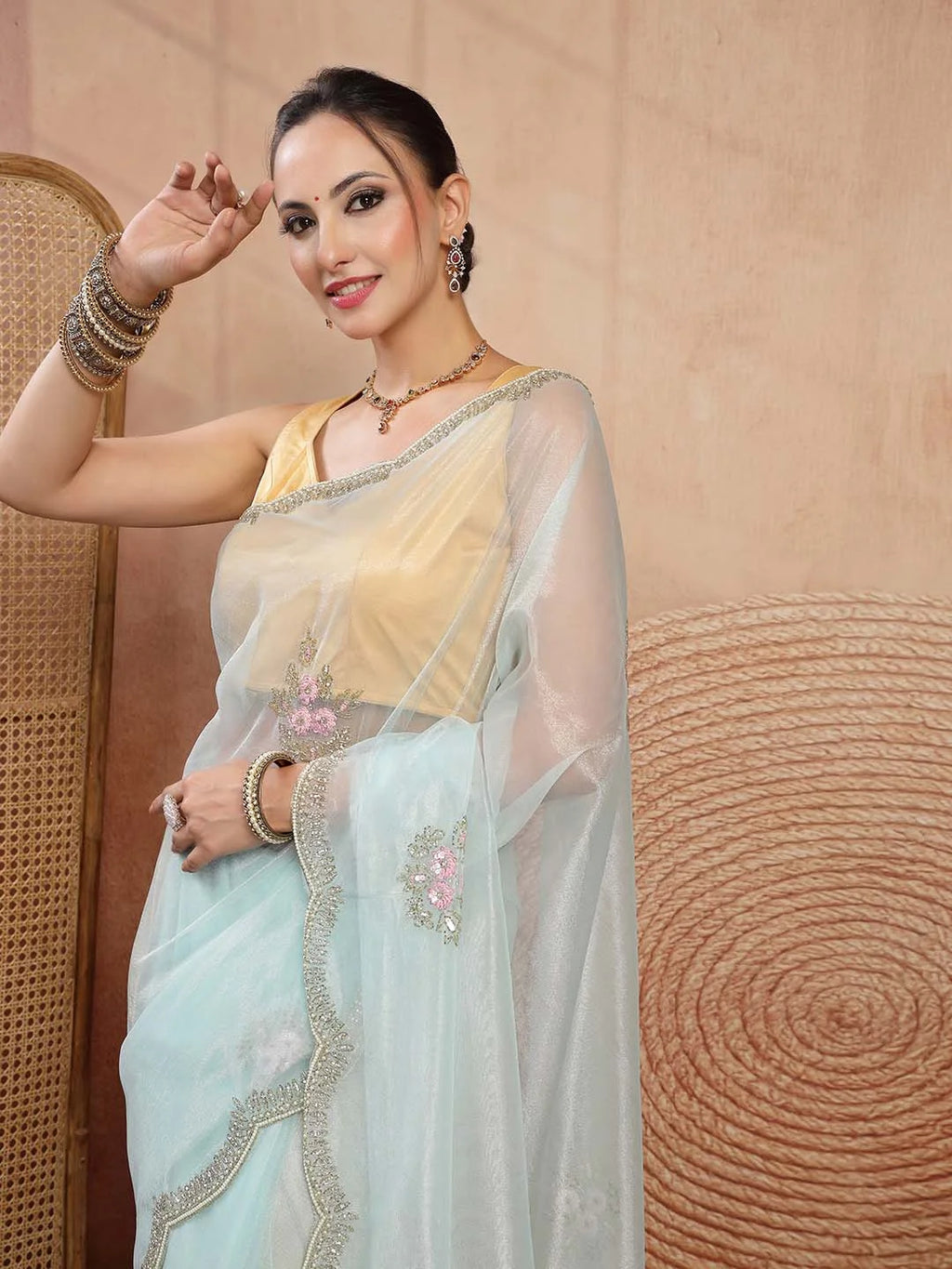 Model Wearing Mint Green Net Saree with Pink Floral Threadwork