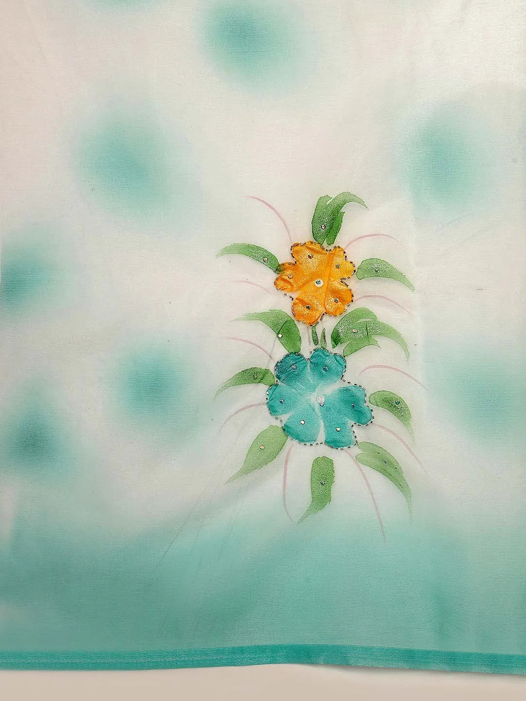 Close up Shot of Handpainted Teal and Yellow Floral Motif on Tissue