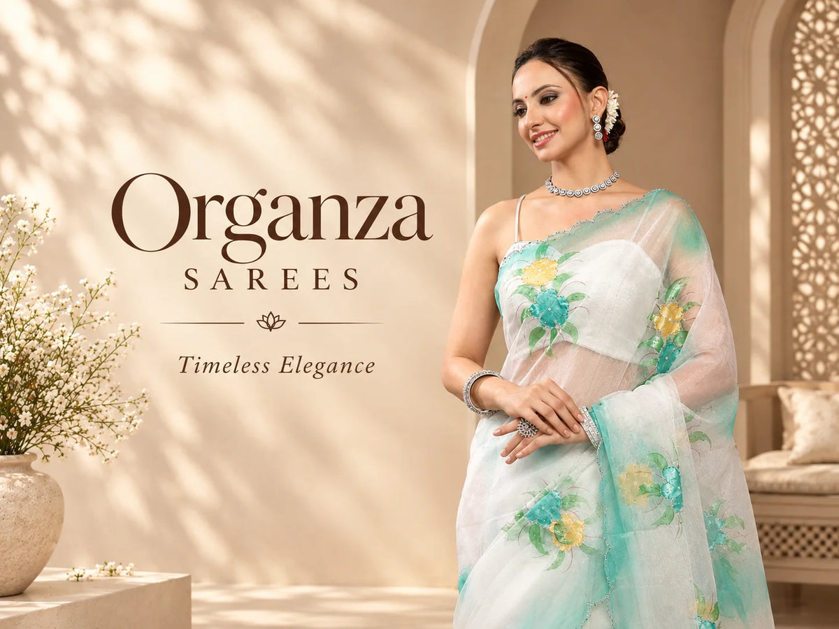 A woman models a white organza saree with light blue and yellow floral embroidery.