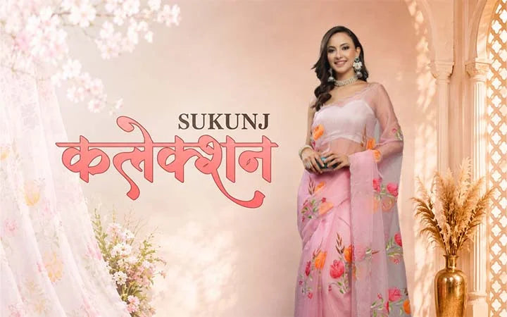 A woman modelling a pink floral sukunj saree.